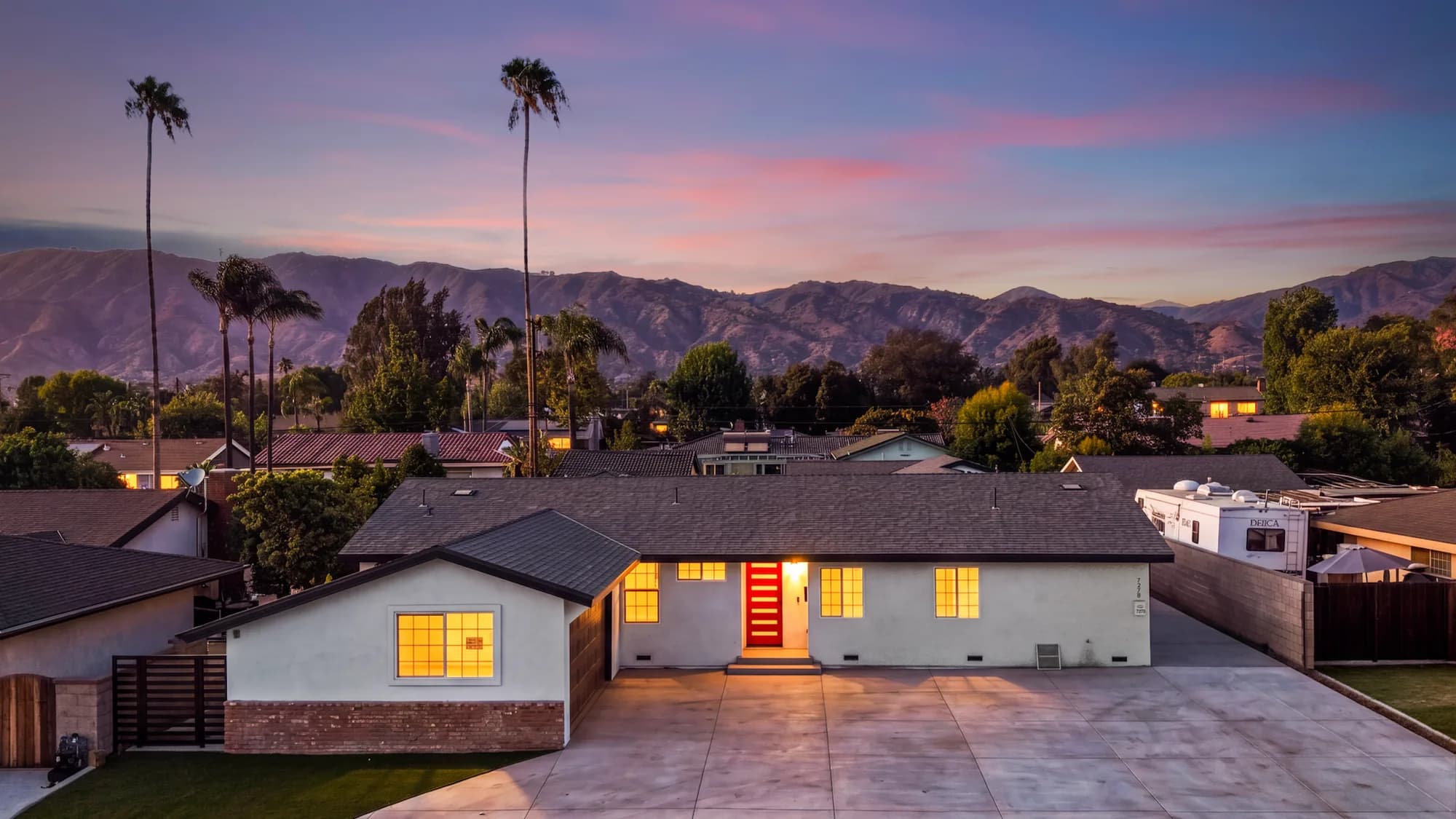 Aerial real estate photography of a modern home at sunset with mountain views, captured for property video production